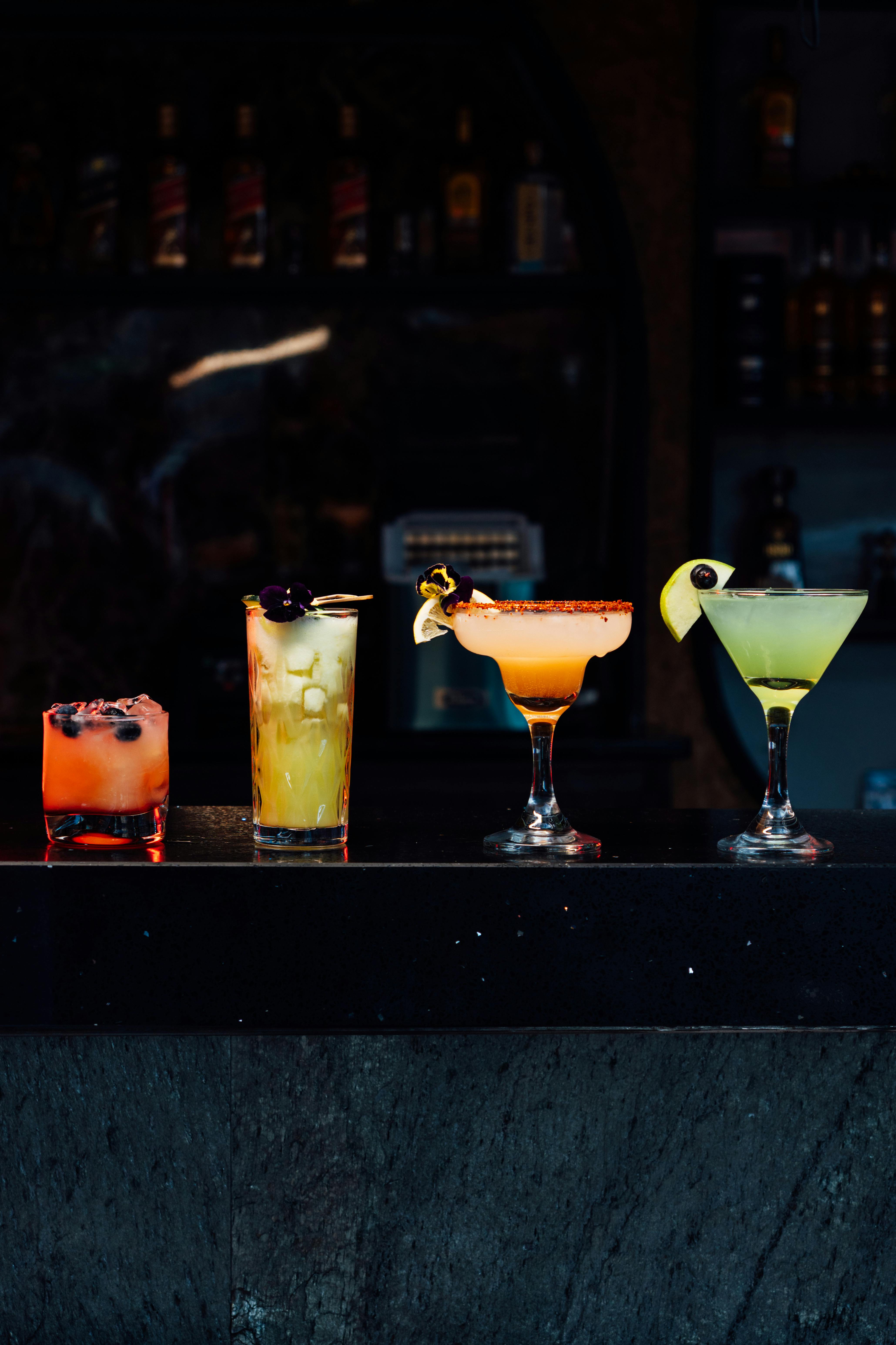 A luxurious spread of cocktails on a bar.